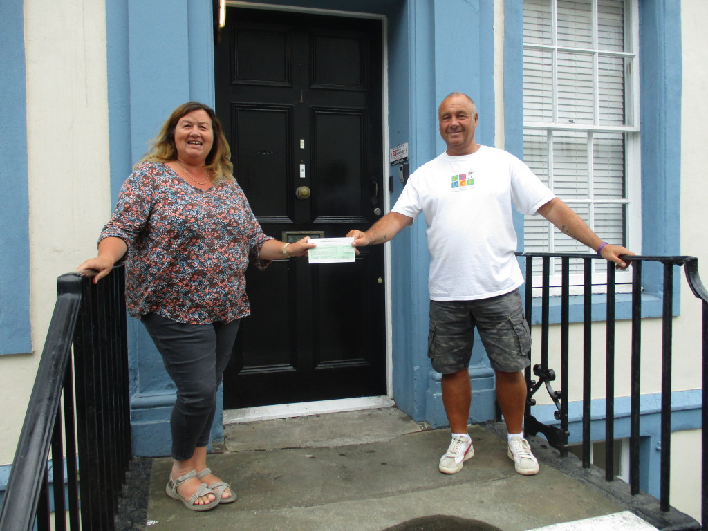 Mark Andrews, CKDCF Trustee, hands over the cheque to WCT
